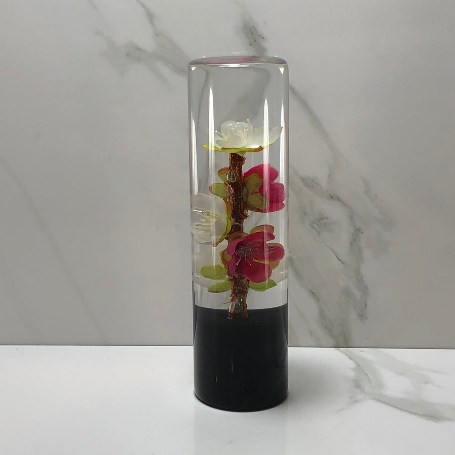 Pressed blossom, held on axis